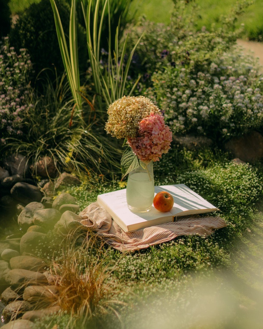 Flowers and vintage books on a garden stone ledge